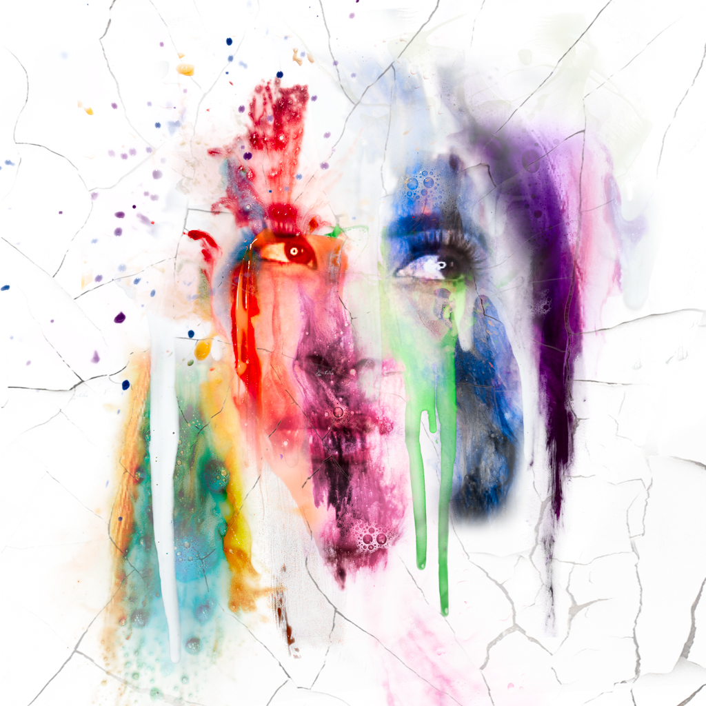 Woman face made of rainbow colored liquid splashes and drips.