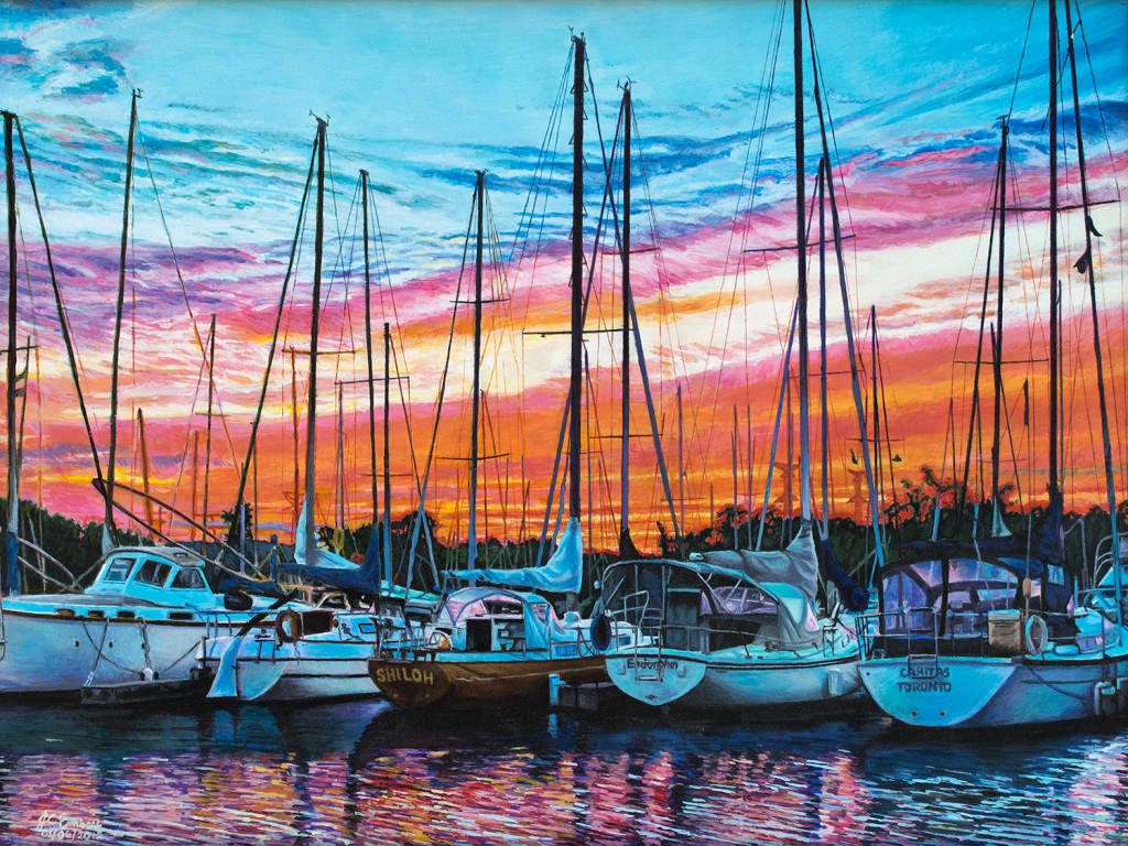 Sailboat masts reach into a pink and orange sky at sunset in Whitby harbour.
