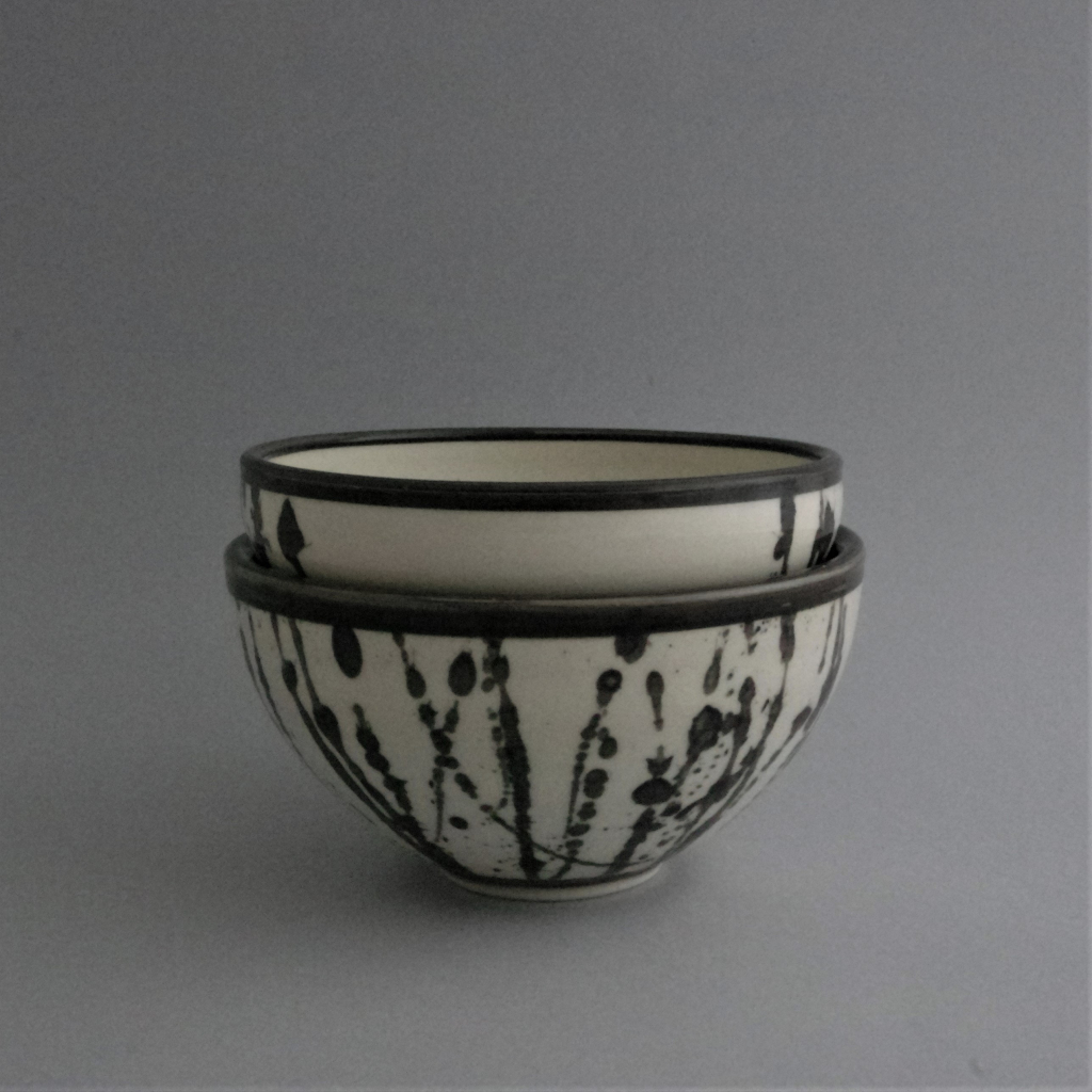 Porcelain bowls (medium, e.g. for soup, salad) with black clay splattered in abstract pattern, finished with a clear glaze.