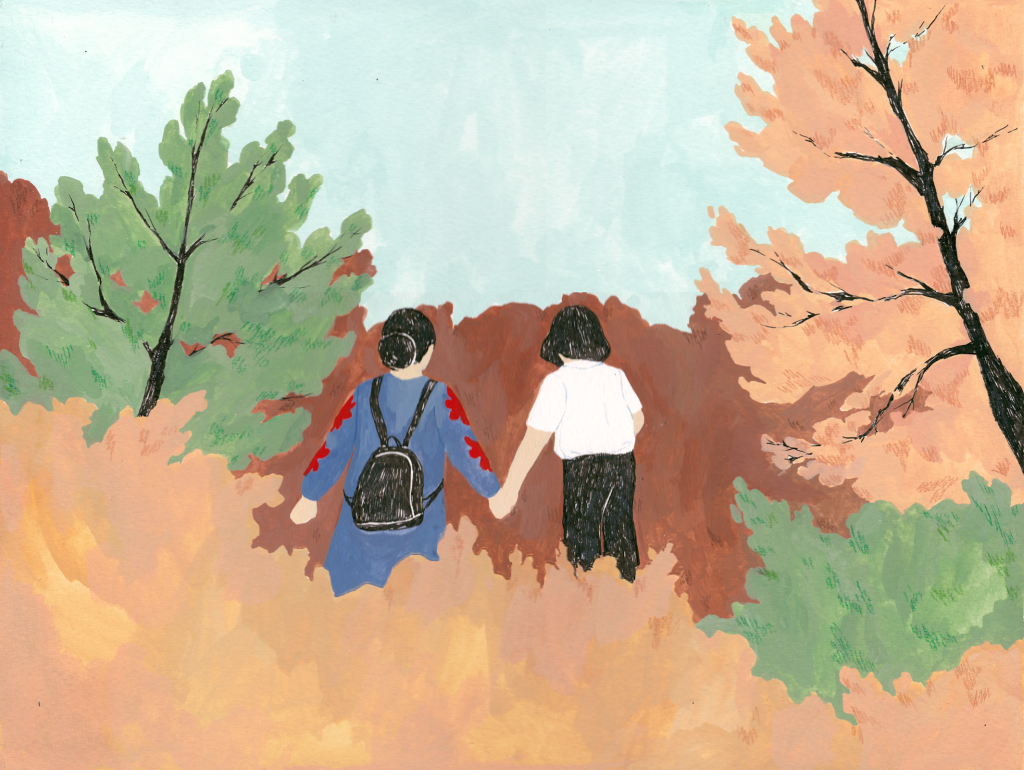 Two people in a fall-seasoned forest.