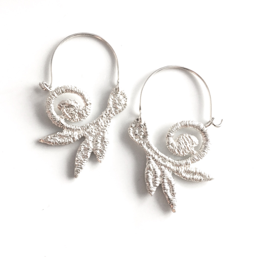 Sterling Silver hoop earrings made from cast lace. Vine and scroll shape. Hook and catch closure. Approx. 1.5 inches long.