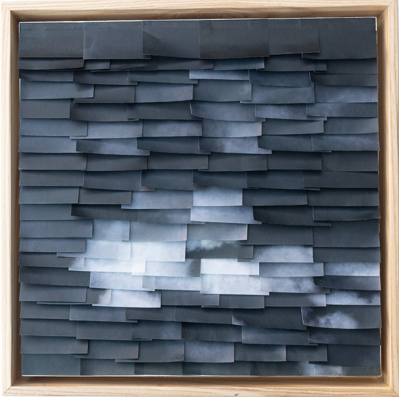 black and white photography printed on Japanese paper cut in small pieces and collaged back together bottom edges curved out