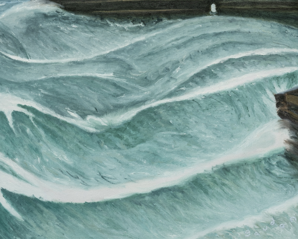 Large turquoise ocean waves crashing against 2 wharfs