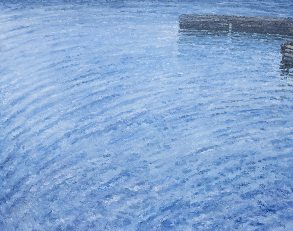 Sparkling blue ocean waves with wharf in the distance