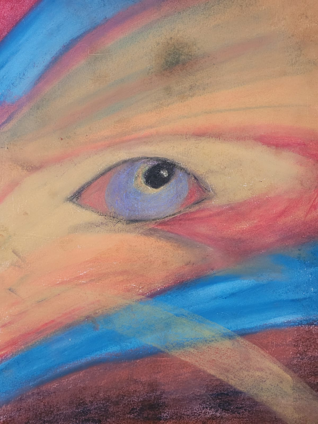 An image of a blue eye looking towards the sky, streams of yellow, blue and red colour cross the page.